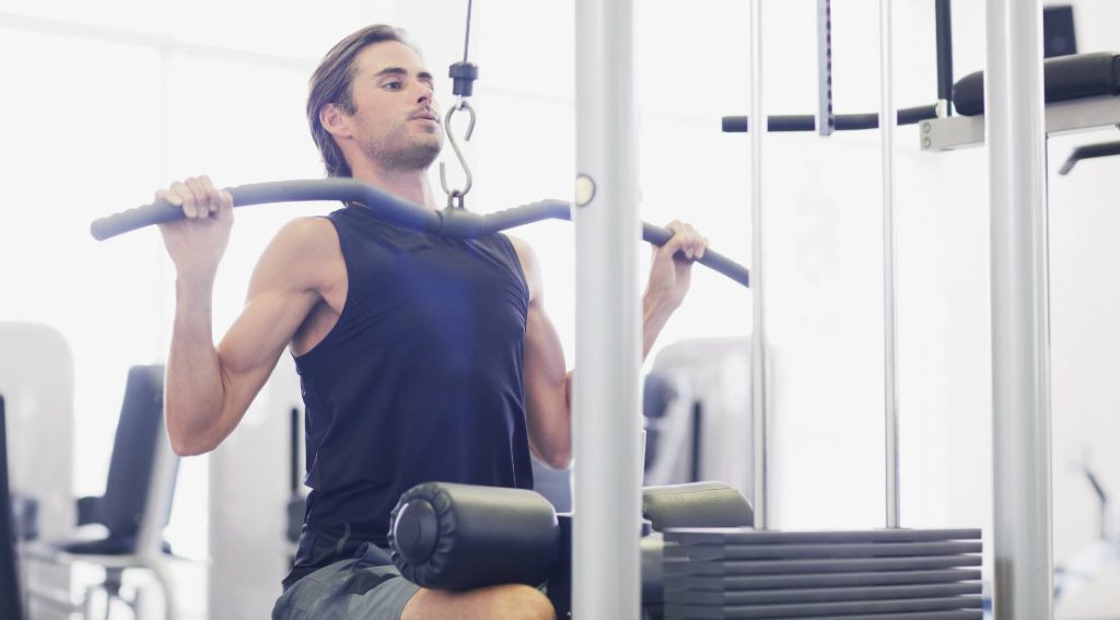 Handsome man exercise with dumbbell in the gym