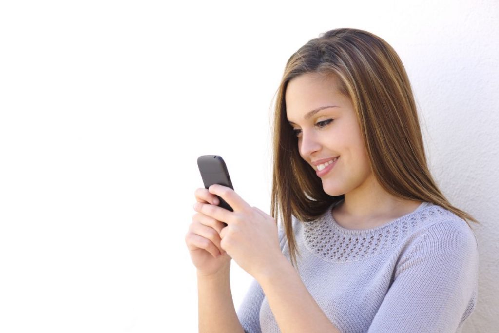 woman texting and smiling