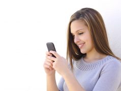 What is your text message to flatter him or her? woman texting and smiling