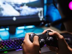 Selecting the gaming computers cheap option hands holds a console infront of computer