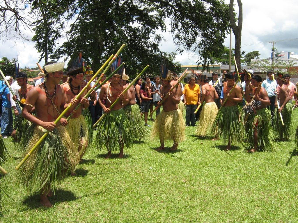 A group of people that are standing in the grass