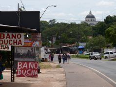 The Pilgrimage to Caacupé A sign on the side of the street