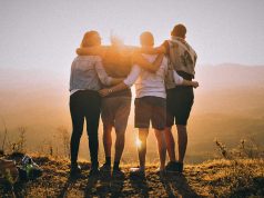 Happy friendship Day! A group of people standing on a beach