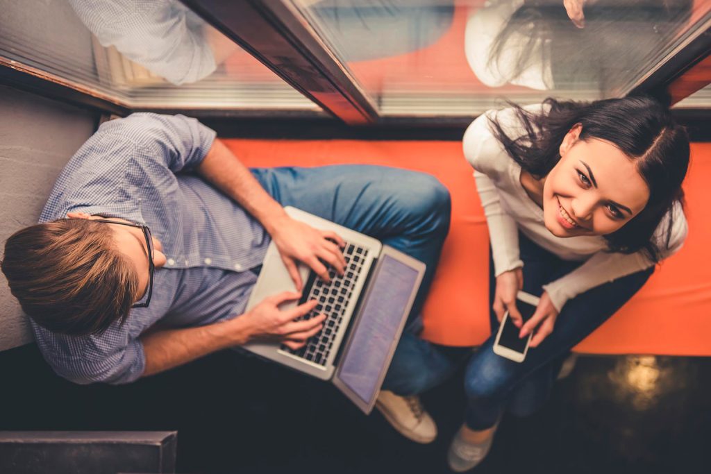 A man lying on a laptop